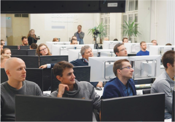 Students sitting in a computer auditorium and listening to lectures.